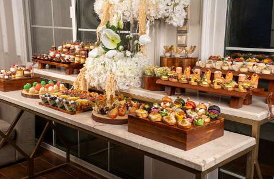 House of Savour catering table with canapés, burgers and desserts